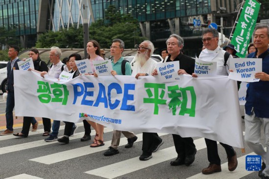 7月22日，在韓國首爾，人們手舉標語參與反戰游行。新華社發（楊暢 攝）